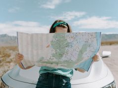 These 8 Countries Now Require Travel Insurance Upon Entry Woman Looking At The Map