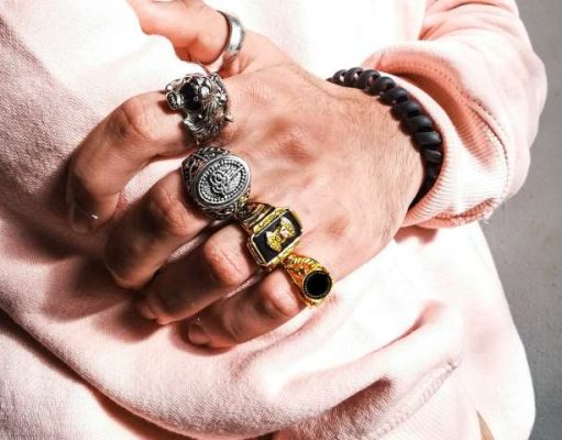 Carry Your Memories on Your Finger – Wearable Art Inspired by Exotic Travel Destinations mans hand with many rings