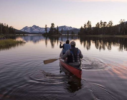 Explore Indigenous-owned Resorts and Experiences in BC canoing at an Indigenous-owned Resorts in BC