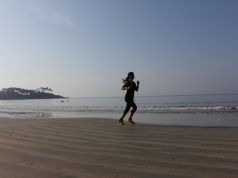 Places to Exercise when You’re on the Road girl running on the beach at sunrise