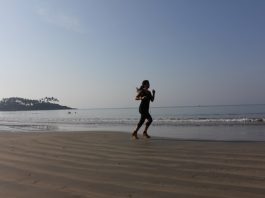 girl running on the beach at sunrise