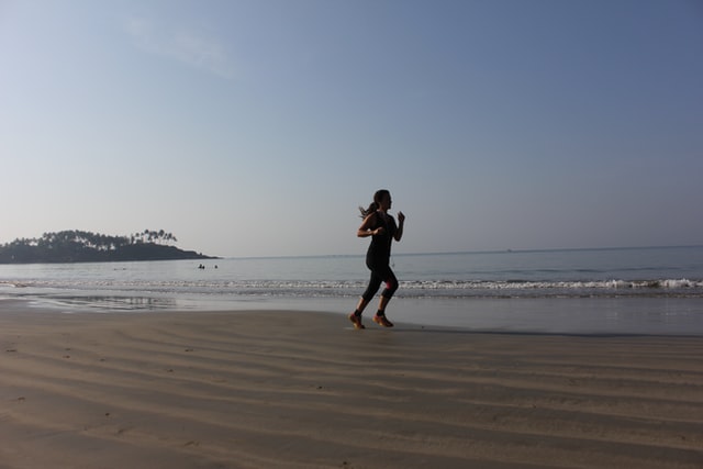 girl running on the beach at sunrise