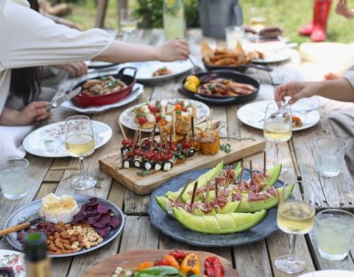 Planning the perfect neighborhood picnic: Tips and tricks to keep in mind picnic table full of food