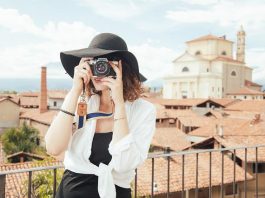 girl traveling with camera taking photo
