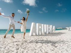 Love Conquers All On the One Happy Island: Aruba to Host Fourth Annual Vow Renewal wedding couple on beach in Aruba