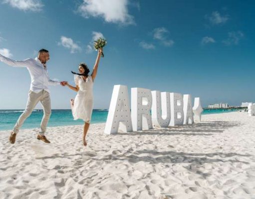 Love Conquers All On the One Happy Island: Aruba to Host Fourth Annual Vow Renewal wedding couple on beach in Aruba