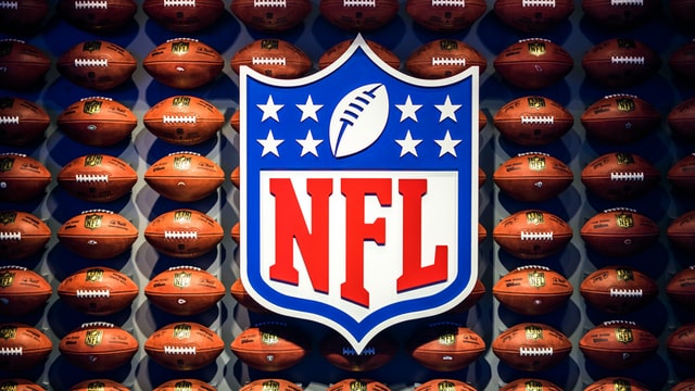 NFL logo on a wall of footballs