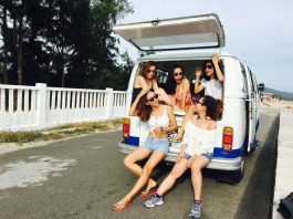 Photo of Five Women Sitting in Back of Van