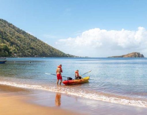 Dominica Brings New Deals and Non-Stop Flights to The Nature Island Kayak on beach