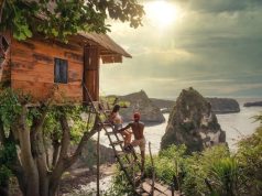 Why is Backpacking the Best Way to Travel? Couple Sitting on Brown Wooden Ladder Bali, Indonesia