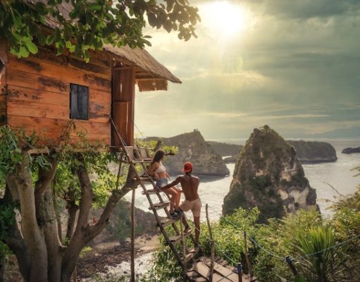 Why is Backpacking the Best Way to Travel? Couple Sitting on Brown Wooden Ladder Bali, Indonesia