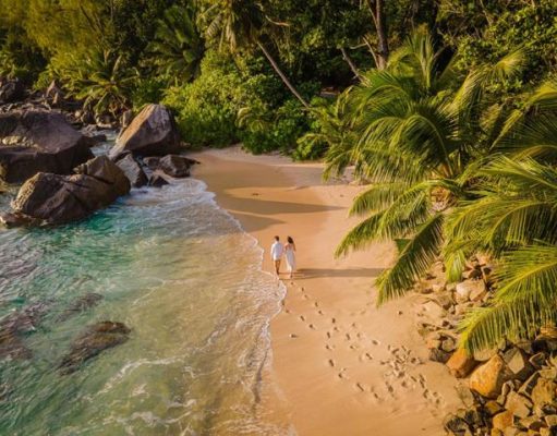 The 10 must do experiences when in the Seychelles for your wedding or honeymoon Married couple on beach