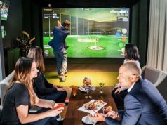 The Ritz-Carlton, St. Thomas Tees Off with New Topgolf Swing Suite People enjoying dinner and golf simulator
