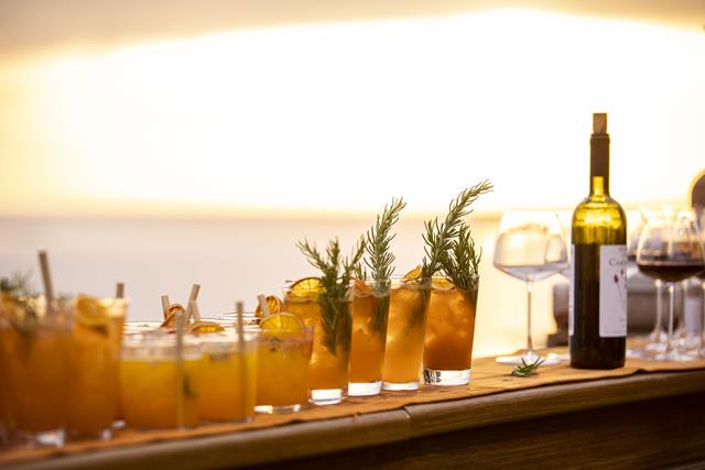 Bottles on a bar with glasses 