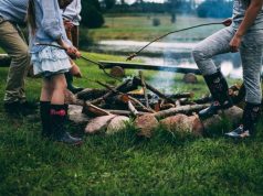 10 Tips for Camping With Kids kid around a campfire