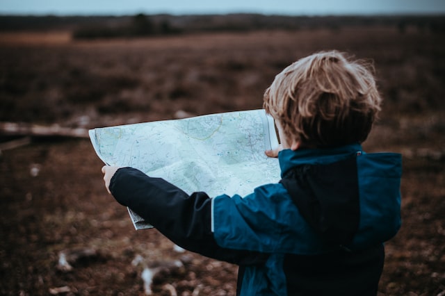 child looking at a map