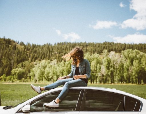 How Dangerous Is Car Travel? 6 Tips For More Safety When Driving girl sitting on the top of a car