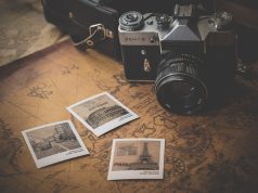 Effective Ways To Make Your Travel Budget Go Further travel photos and camera on a table