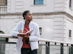 5 Must-Dos Before Moving into Student Accommodation girl reading a book on a bridge