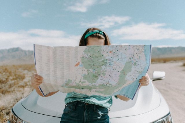 girl traveling looking at map