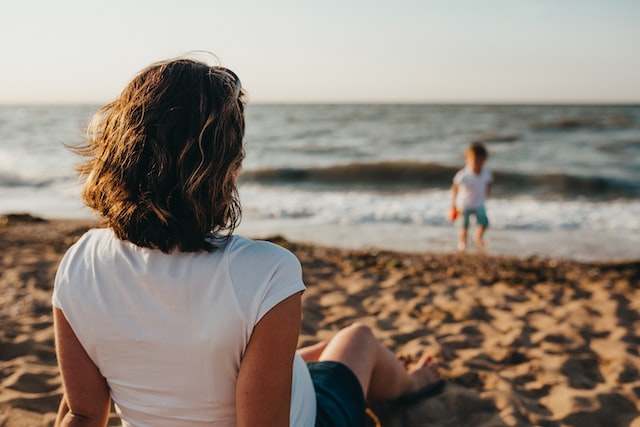 mother watching child on a beach