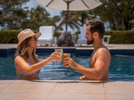 couple having cocktails by a resort pool