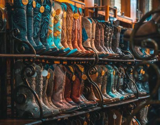 Add Cowboy Boots to Your Fall Outfits—Here’s How cowboy boots on a display rack