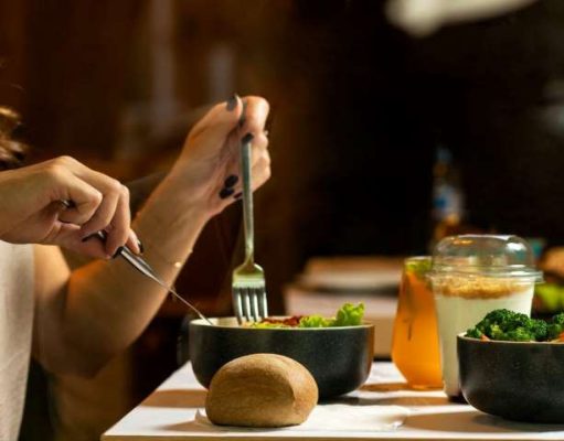 Best Healthy Takeout Restaurants in NYC for Online Ordering lady at a table eating a salad
