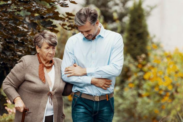 senior-mother-and-son-walking-in-garden