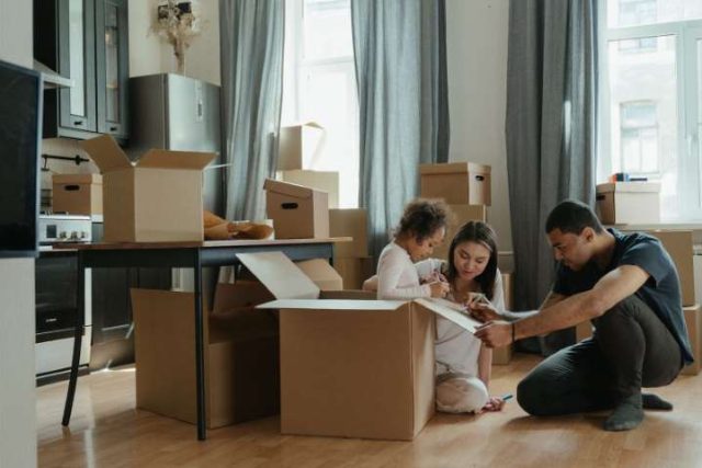 family packing boxes getting ready to move