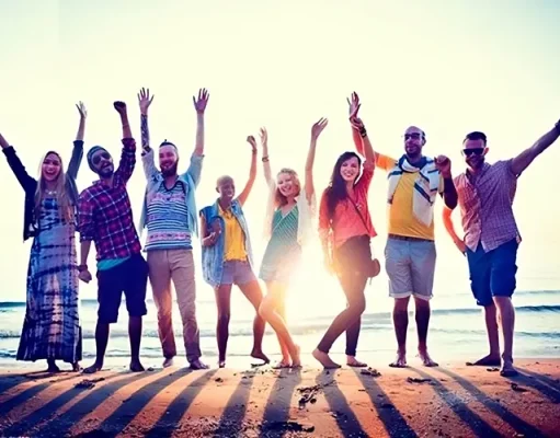 A Second Summer of LGBTQ+ Events, Festivals and Cape Cod’s Glorious Fall Weather LGBTQ+ travelers on a beach waving