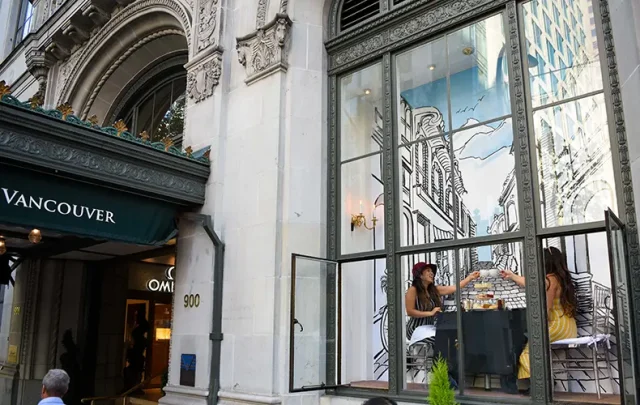 people having tea in the widow of Fairmont Hotel Vancouver