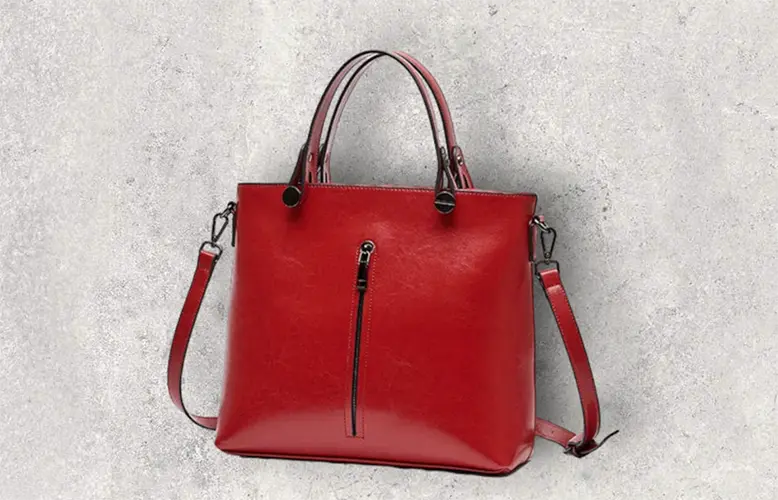 a bright red handbag set against a stark white backdrop