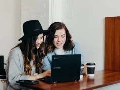 You Won’t Believe How Travel Videos Are Transforming Tourism! two girls watching travel videos on a laptop