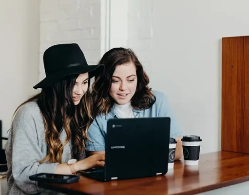 You Won’t Believe How Travel Videos Are Transforming Tourism! two girls watching travel videos on a laptop