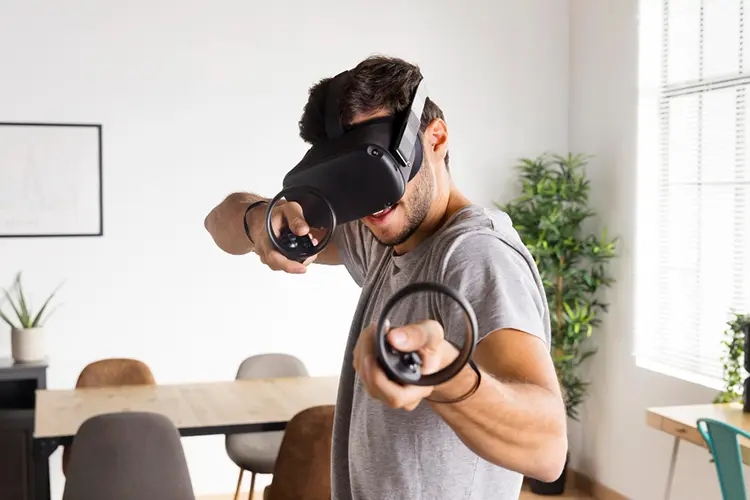 man holding vr gaming controllers 