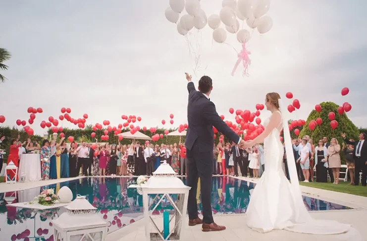 couple releasing balloons at their wedding