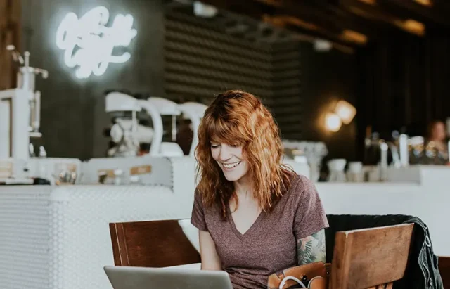 Tattooed woman with laptop