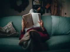 7 Benefits of Investing in Professional Transcreation Services person lying on their back reading a book