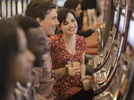 group of people playing the slot machines in a casino