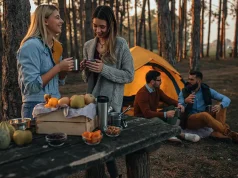 7 Useful Tips To Make Your Fall Camping Comfortable Young women enjoying hot drink at the forest during autumn weekend