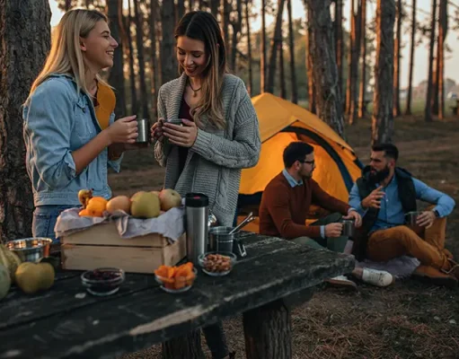 7 Useful Tips To Make Your Fall Camping Comfortable Young women enjoying hot drink at the forest during autumn weekend