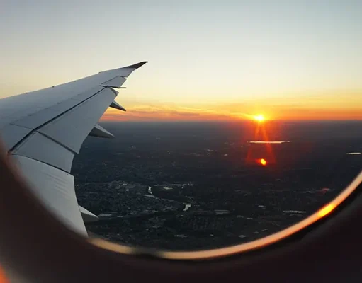 Why Travel-Based Team Building Inspires Collaborative Excellence Sunset seen from a plane