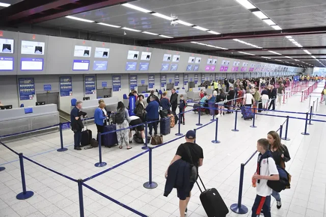 people inline at an airport check in