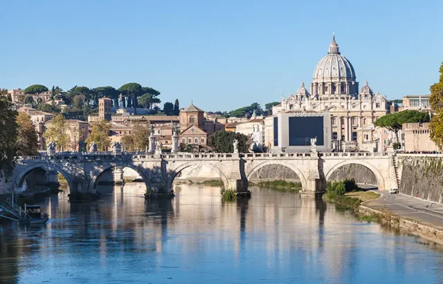 Rome and Vatican city skyline with Basilica St. Peter's, Tiber river, Ponte Sant' Angelo (Bridge of Holy Angel) in autumn morning
