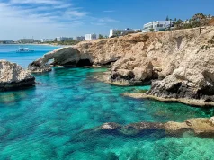 Europe’s Sunniest October Destinations For a Fall Getaway vivid blue waters of Ayia Napa beach in Cyprus