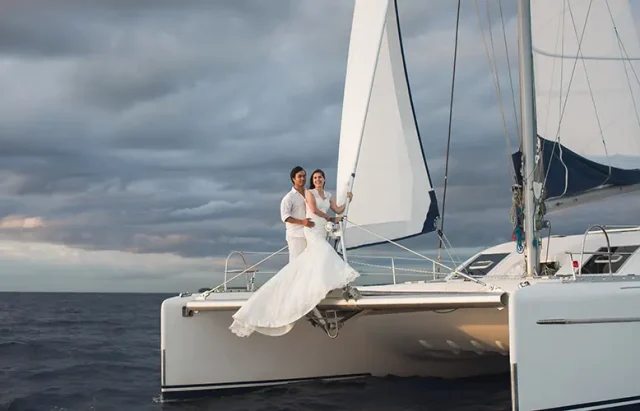 Wedding couple is hugging on a yacht.