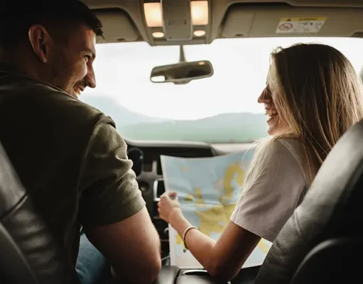 Top Road-Trip Worthy Vehicles: Exploring the Best Options for Your Next Adventure Young loving couple on a road trip using map inside a car