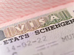 Visiting Schengen? Here’s Why You Still Need Travel Insurance Macro shot biometric passport with schengen visa. European visitor visa for tourism and travel in EU