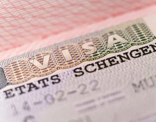 Visiting Schengen? Here’s Why You Still Need Travel Insurance Macro shot biometric passport with schengen visa. European visitor visa for tourism and travel in EU